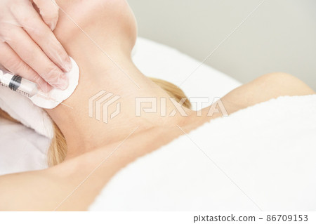 Injection at spa salon. Doctor hands in gloves. Closeup. Pretty female patient 86709153