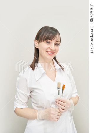 Doctor with cosmetology brushes. Hospital equipment. Online patient examination Doctor with cosmetology brushes. Hospital equipment. Online patient examination 86709167