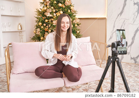 Young woman doing self portrait indoors. Home vacation portrait. Blogger selfie. Young woman doing self portrait indoors. Home vacation portrait. Blogger selfie. 86709182