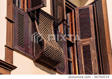 architectural elements of a historic house, beautiful windows with shutters, blinds and wooden bars architectural elements of a historic house, beautiful windows with shutters, blinds and wooden bars 86709554