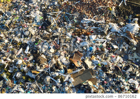 Garbage dump with plastic bags and food waste.  86710162