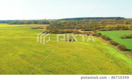 4K Aerial Elevated View Of Combine Harvester And Tractor Working Together In Field. Harvesting Of Oilseed In Spring Season. Agricultural Machines Collecting Rapeseeds Canola Colza Rural Landscape 4K Aerial Elevated View Of Combine Harvester And Tractor Working Together In Field. Harvesting Of Oilseed In Spring Season. Agricultural Machines Collecting Rapeseeds Canola Colza Rural Landscape 86710349