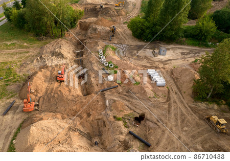 Excavator dig ground at a construction site.  86710488
