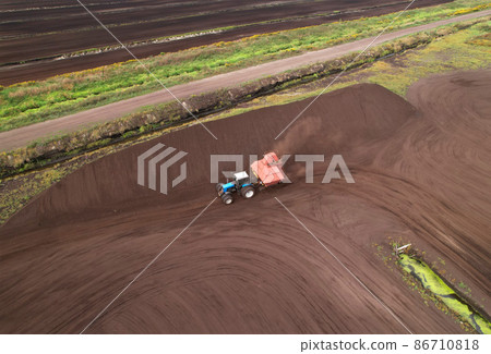 Peat Harvester Tractor on Collecting Extracting Peat. Peat Harvester Tractor on Collecting Extracting Peat. 86710818