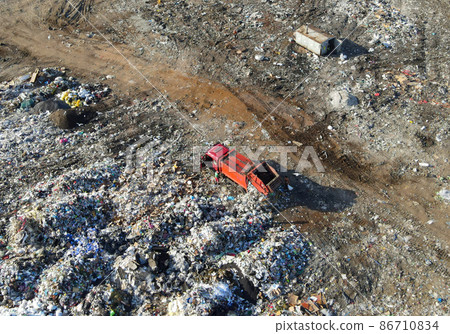 Arial view of garbage truck during unloading the rubbish and food waste.  86710834