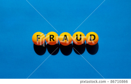 Fraud symbol. Orange table tennis balls with the words 'fraud'. Beautiful blue background, copy space. Warm sunshine. Business, fraud concept. 86710866