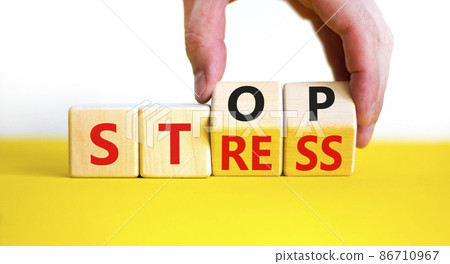 Stop stress and be health symbol. Doctor turns cubes and changes words 'stress' to 'stop'. Beautiful yellow table, white background. Psychological, business and stop stress concept. Copy space. Stop stress and be health symbol. Doctor turns cubes and changes words 'stress' to 'stop'. Beautiful yellow table, white background. Psychological, business and stop stress concept. Copy space. 86710967