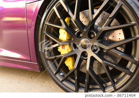 Alloy wheel with calipers and racing brakes of the sport car. Racing brake disc  86711404