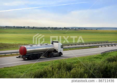 Isothermal Tank truck driving on highway. Oil and Gas Transportation and Logistics. Isothermal Tank truck driving on highway. Oil and Gas Transportation and Logistics. 86711436
