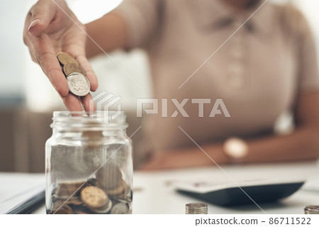 Storing a few extra pennies into the money jar Storing a few extra pennies into the money jar 86711522