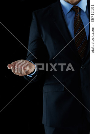 Leading you to business success. Shot of an unrecognizable businessman holding out his hand. 86712191