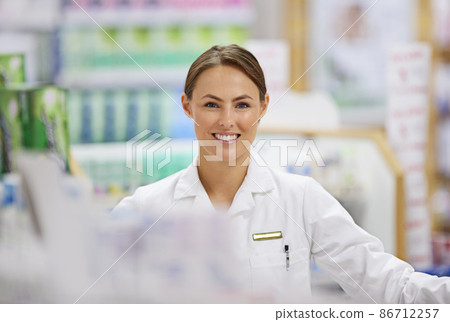 Assisting you with your medicinal needs. Portrait of an attractive young pharmacist at work. 86712257