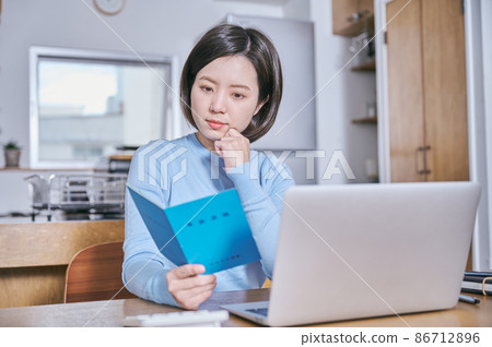A young woman staring at the pension book 86712896