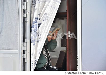 Female using a tablet in a camper Female using a tablet in a camper 86714242