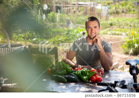 Young man gardener resting after harvesting of vegetables 86715856