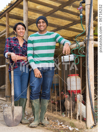 Man and woman farmers at poultry farm 86716282