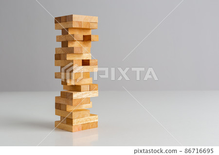 Tower wooden block, builds tower from wooden blocks on grey background. Tower wooden block, builds tower from wooden blocks on grey background. 86716695