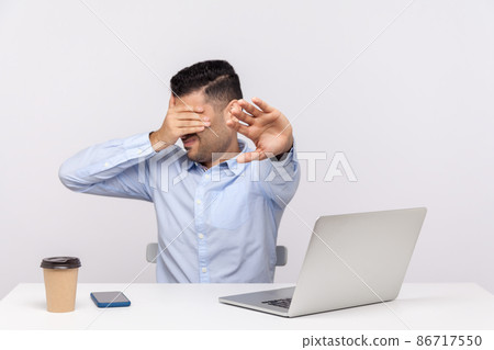 No, don't want to look. Businessman sitting office workplace with laptop on desk, covering eyes showing stop gesture, avoiding watch something unpleasant. studio shot isolated on white background 86717550
