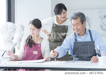 Senior male and female instructors attending a watercolor painting class at a culture school Senior male and female instructors attending a watercolor painting class at a culture school 86717691