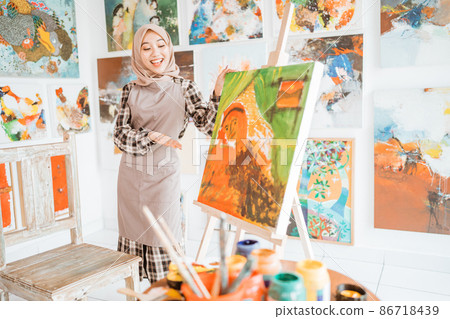 female painting artist showing and presenting her work 86718439