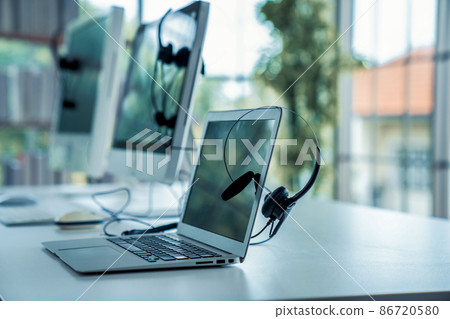 Headset and customer support equipment at call center ready for actively service Headset and customer support equipment at call center ready for actively service 86720580