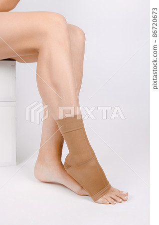 Orthopedic Ankle Brace. Medical Ankle Bandage. Medical Ankle Support Strap Adjustable Wrap Bandage Brace foot Pain Relief Sport. Leg Brace isolated on white background. Trauma Ankle orthosis. Injury. 86720673