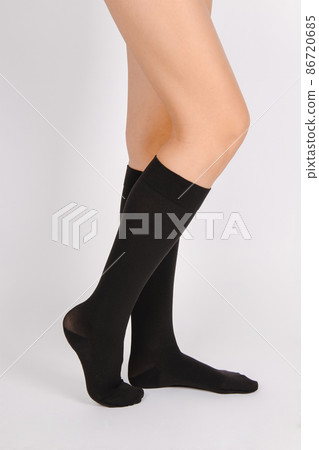 Medical Compression Stockings for varicose veins and venouse therapy. Compression Hosiery. Sock for sports isolated on white background. Black color socks mock up for advertising, branding, design. 86720685
