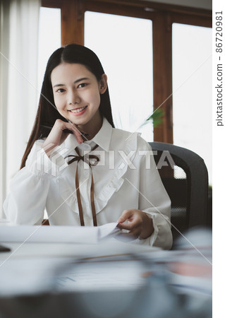 Asian Businesswoman or Accountant hands holding paperwork with calculator, account and saving concept 86720981