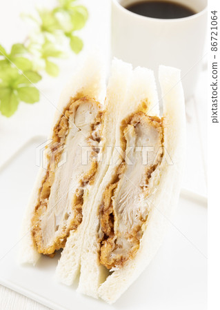 Delicious chicken cutlet sandwich and hot coffee 86721064