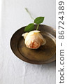 Place a single rose on an antique brass plate 86724389