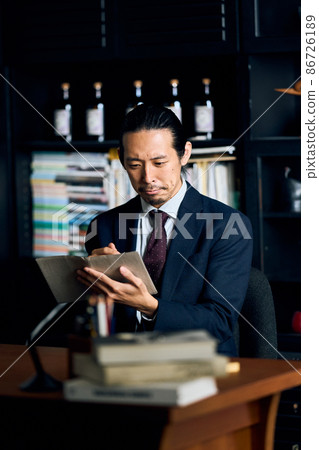 Men in suits taking notes Men in suits taking notes 86726189
