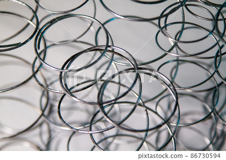 Production of independent springs for mattresses. Independent spring blocks packed in spunbond. Coiling and hardening of springs. Furniture manufacture. Industrial and business concept. Production of independent springs for mattresses. Independent spring blocks packed in spunbond. Coiling and hardening of springs. Furniture manufacture. Industrial and business concept. 86730594