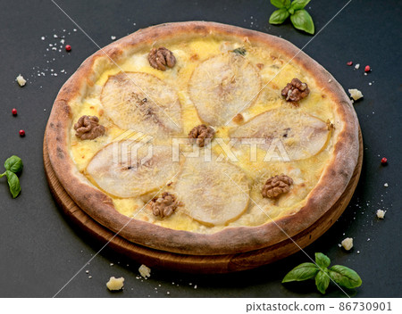 Fruit homemade sweet pear pizza with cheese and nuts, Rustic Italian savory food with pastry dough, top view, copy space Fruit homemade sweet pear pizza with cheese and nuts, Rustic Italian savory food with pastry dough, top view, copy space 86730901