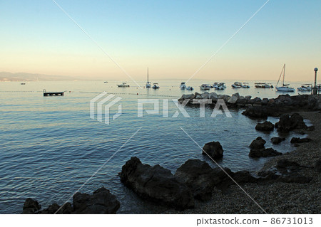 View from Opatija's seaside promenade, little harbor, beach and anchorage for vessels, Adriatic coast, Kvarner bay, city details, Croatia View from Opatija's seaside promenade, little harbor, beach and anchorage for vessels, Adriatic coast, Kvarner bay, city details, Croatia 86731013