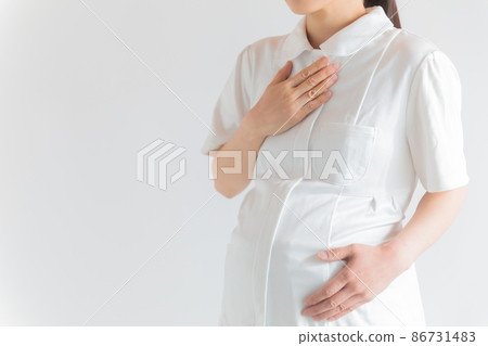 Working pregnant nurses hold down their breasts 86731483