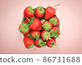 Top view of fresh strawberry in a bowl on isolated pink background. 86731688