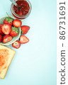 Top view of toast strawberries and jam on isolated pastel background with copy space. 86731691