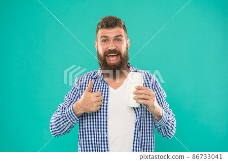 Hair conditioner or lotion. Man bearded hipster hold bottle shampoo or shower gel. Hair conditioner or lotion. Man bearded hipster hold bottle shampoo or shower gel. 86733041