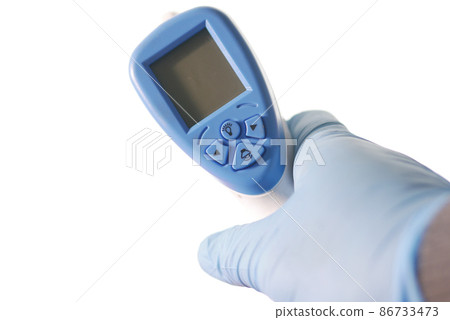 Hand holding infrared thermometer to measuring temperature. 86733473