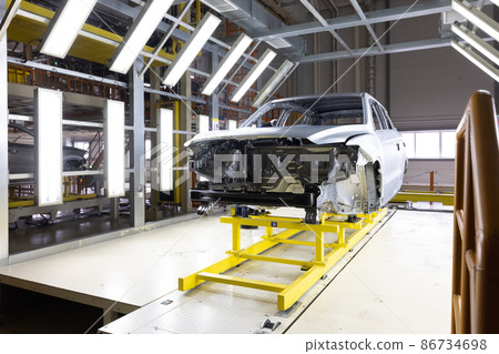 Car bodies are on assembly line. Factory for production of cars. Modern automotive industry. A car Car bodies are on assembly line. Factory for production of cars. Modern automotive industry. A car 86734698