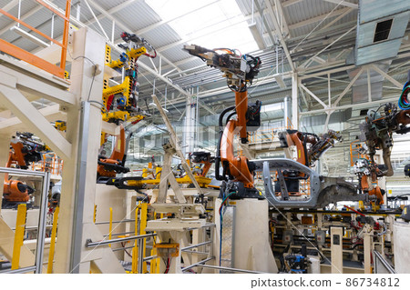 Photo of automobile production line. Welding car body. Modern car assembly plant. Auto industry Photo of automobile production line. Welding car body. Modern car assembly plant. Auto industry 86734812