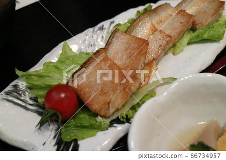 Freshly fried pork slices on a white plate Freshly fried pork slices on a white plate 86734957