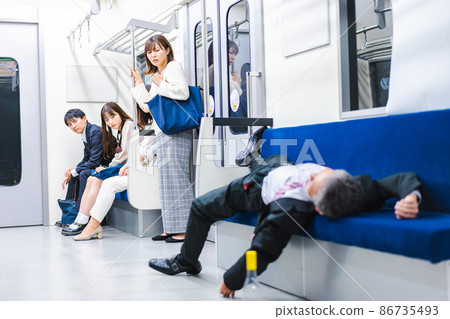 A businessman getting drunk on the train A businessman getting drunk on the train 86735493
