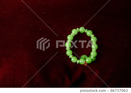 Green porch on red velvet background isolated on black background Green porch on red velvet background isolated on black background 86737063