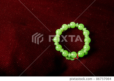 Green porch on red velvet background isolated on black background Green porch on red velvet background isolated on black background 86737064