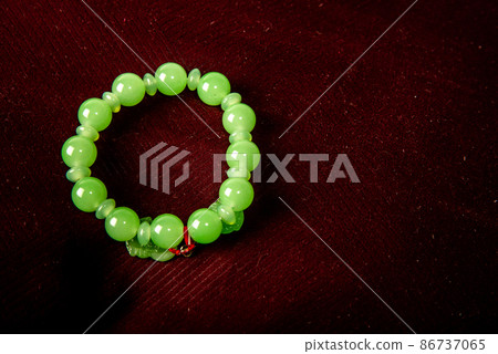 Green porch on red velvet background isolated on black background Green porch on red velvet background isolated on black background 86737065