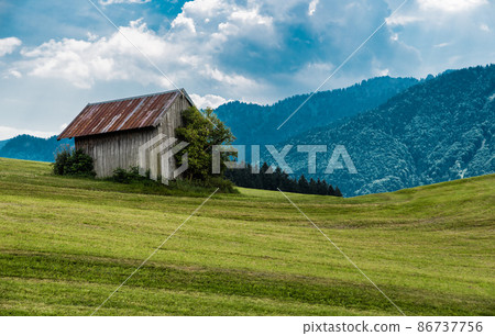 Scenic view over the German countryside around the village Kappel with a wooden shed in the green hills 86737756