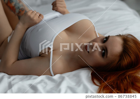 Sensual ginger woman in underwear on bed 86738845