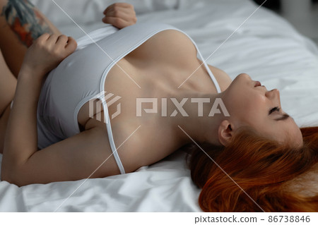 Sensual ginger woman in underwear on bed Sensual ginger woman in underwear on bed 86738846