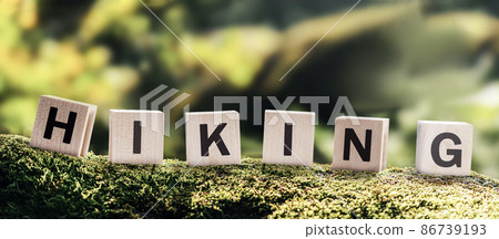 hiking word text on cubes on the background of forest and mountains. logo for the mountain tourism and nature hiking club concept hiking word text on cubes on the background of forest and mountains. logo for the mountain tourism and nature hiking club concept 86739193